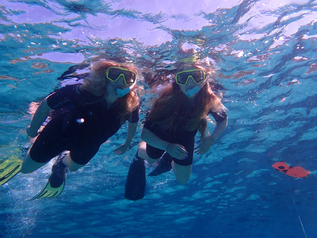 Two guests snorkeling side by side in clear Mediterranean water in Mallorca