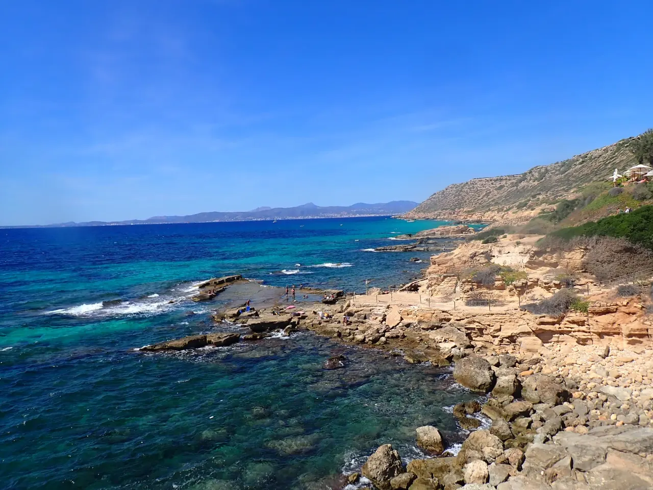 Turquoise Mediterranean water and the rocky Cala Delta coastline in south Mallorca