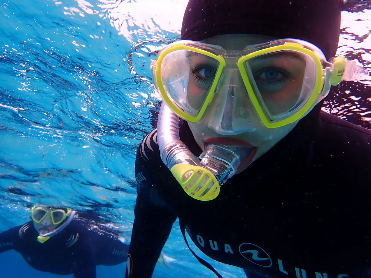 Guest in mask and snorkel in clear Mediterranean water in Mallorca