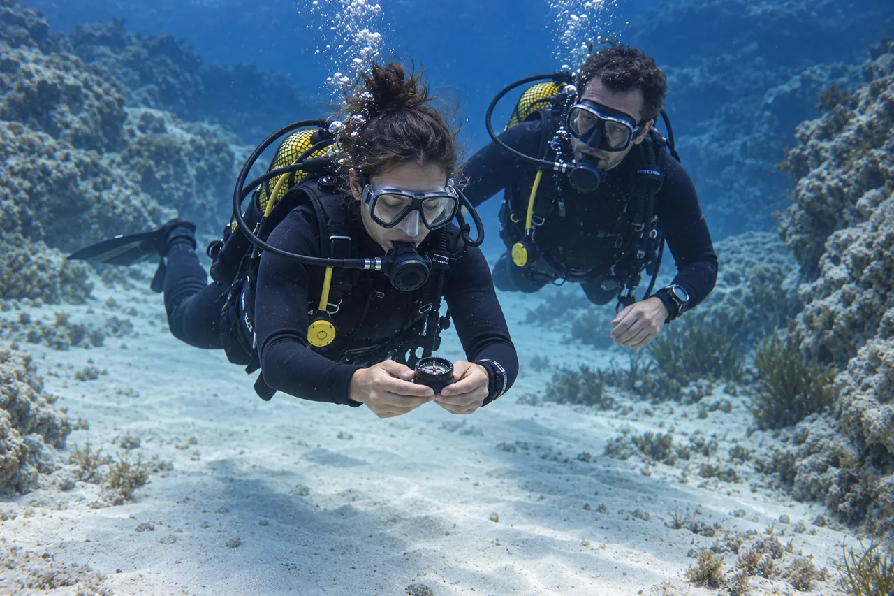 Diver practising underwater navigation with a compass
