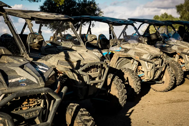 Row of parked, muddy buggies