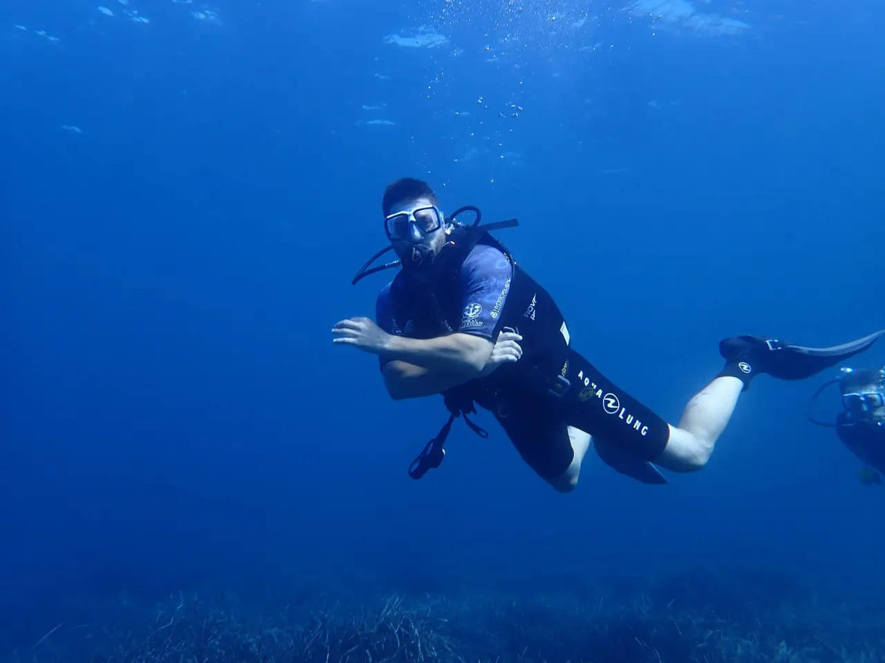 Certified diver gliding over the seabed off Mallorca