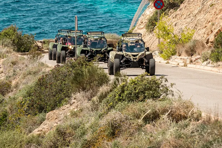 Group of road buggies on a coastal road above the sea